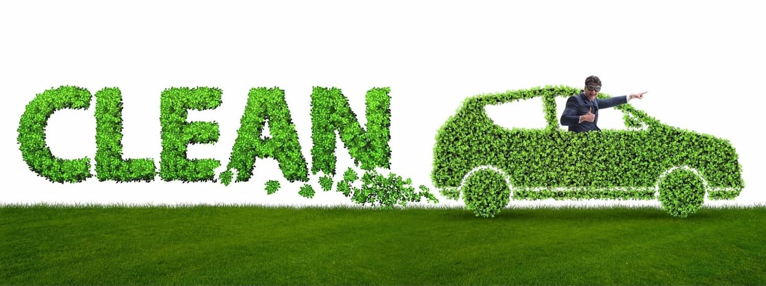 Green Car made from Leaves with the Word CLEAN coming out the Exhaust